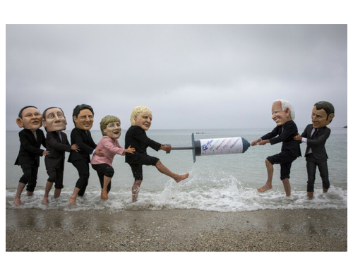 Campaigners from Oxfam and The People’s Vaccine Alliance pose as world leaders at the G7 summit in Cornwall, 2021.