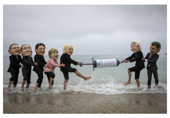 Campaigners from Oxfam and The People’s Vaccine Alliance pose as world leaders at the G7 summit in Cornwall, 2021.