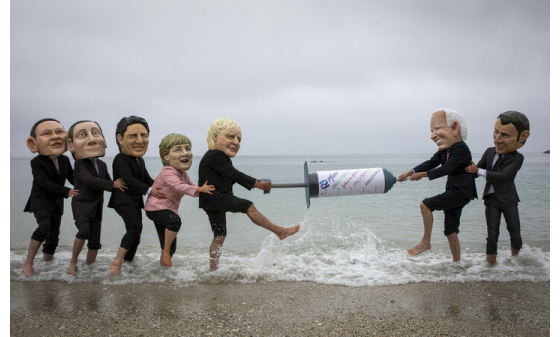 Campaigners from Oxfam and The People’s Vaccine Alliance pose as world leaders at the G7 summit in Cornwall, 2021.