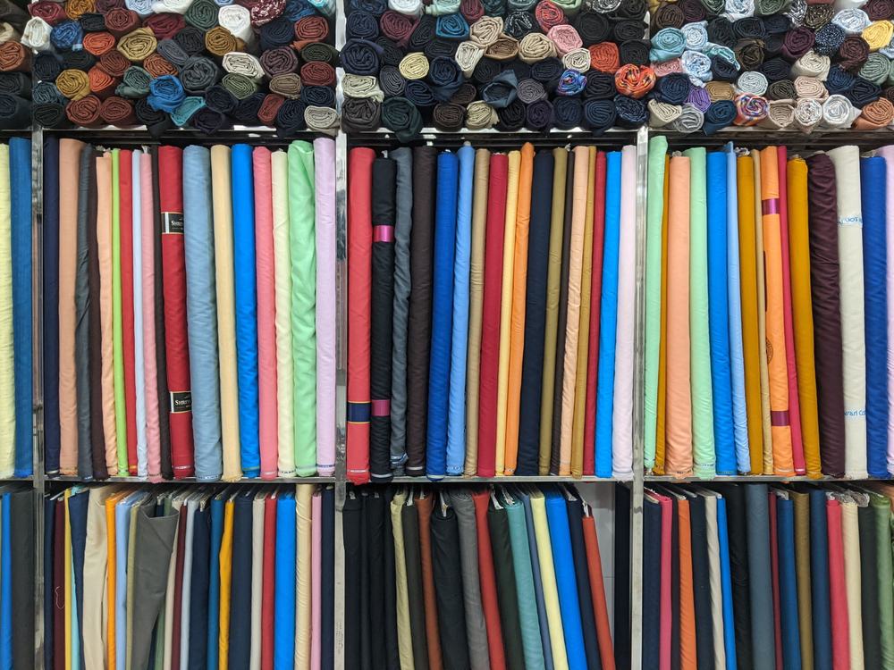 Fabrics of all colours displayed in a fabric store.