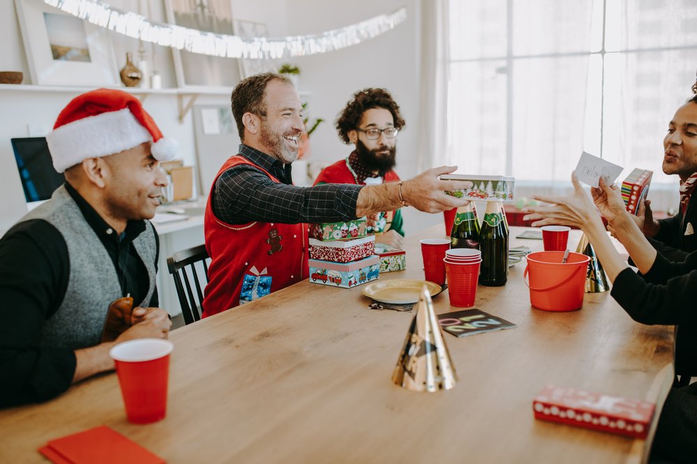 Colleagues in an office exchanging gifts.