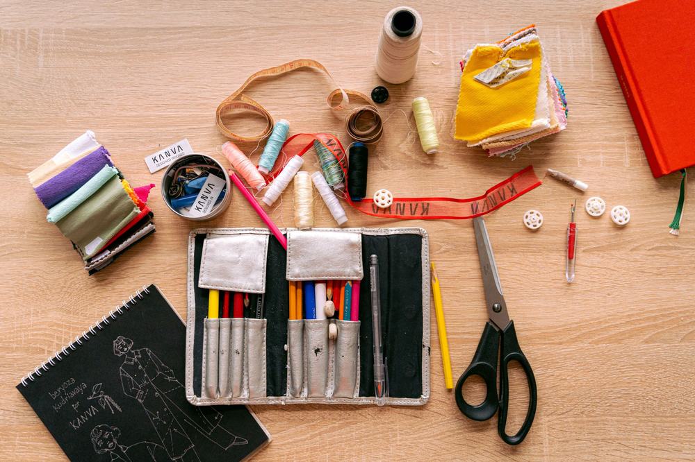 A selection of craft supplies including threads and scissors.