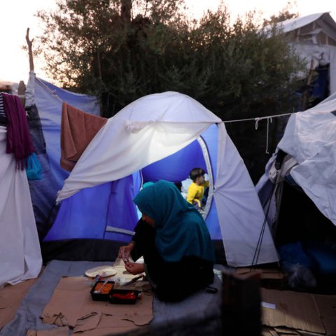 A family in a tent in Moria refugee camp in Greece