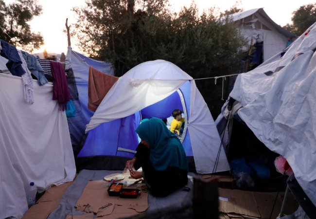 A family in a tent in Moria refugee camp in Greece