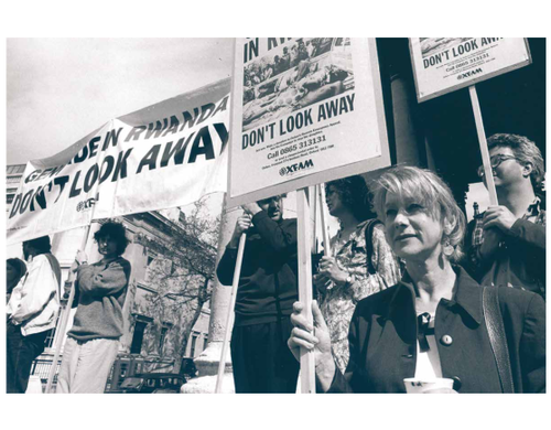 Protestors holding signs reading "Genocide in Rwanda - Don't look away"
