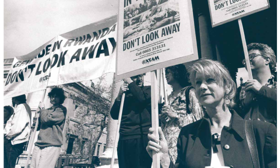 Protestors holding signs reading "Genocide in Rwanda - Don't look away"