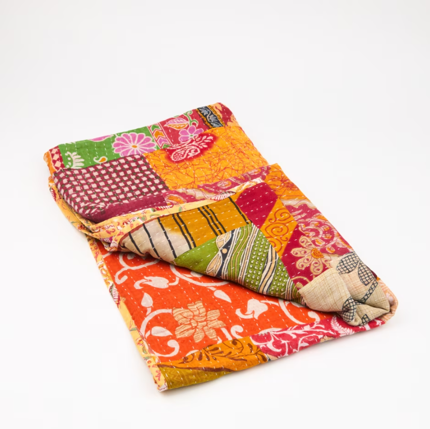 Brightly-coloured throw made from recycled sari fabric