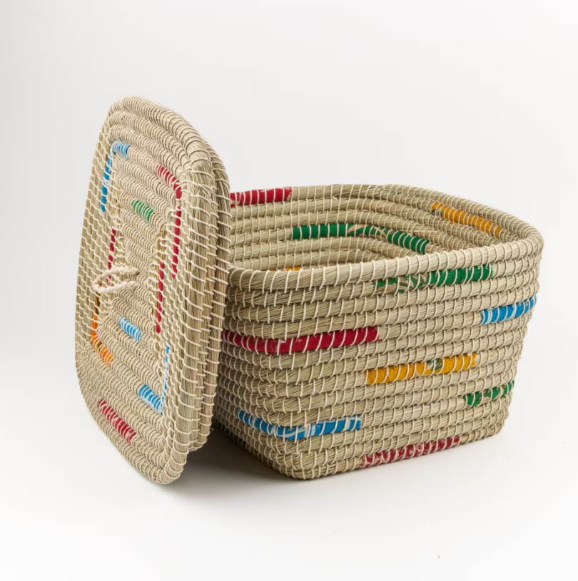 Woven storage basket featuring brightly coloured sections of recycled sari material woven into the design