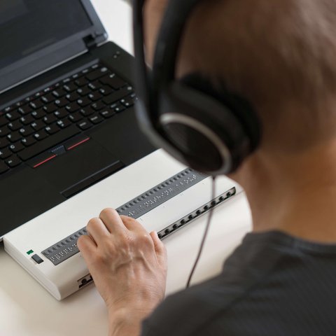 Person using braille keyboard