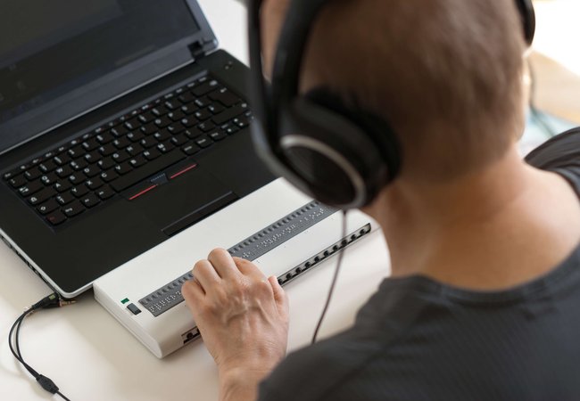 Person using braille keyboard