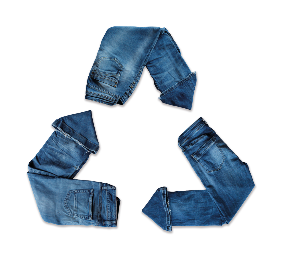 A three arrows recycling symbol made using three pairs of jeans.