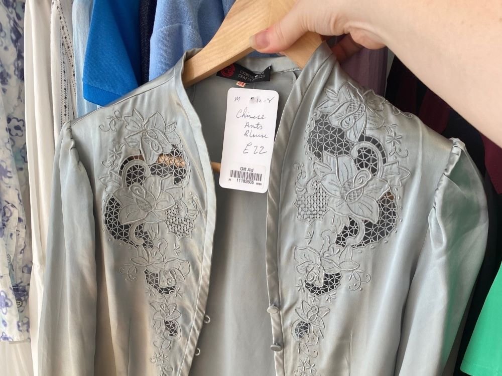 A grey silk vintage shirt with floral detail