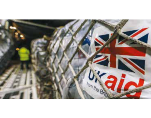 A shipment of aid being loaded with a label reading "UK aid"