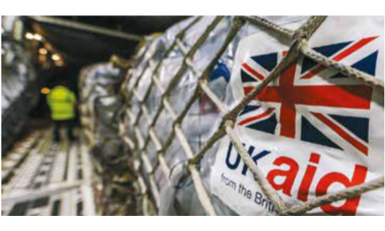 A shipment of aid being loaded with a label reading "UK aid"