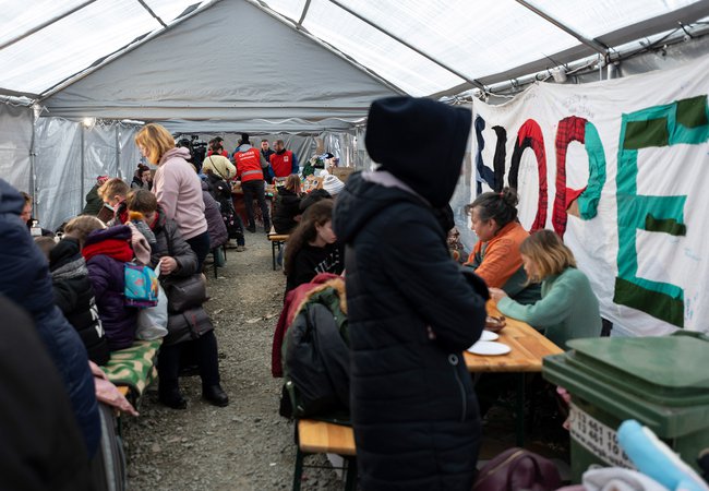 Refugees from Ukraine arriving at a staging area at the Polish border.