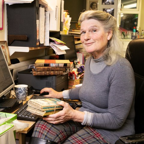 Volunteer smiling sat at a desk in front of a computer