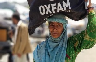 A woman with hygiene supplies distributed by Oxfam in Yemen