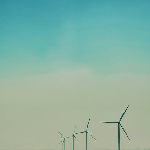 Airplane flying over a windfarm