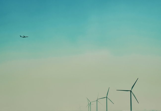Airplane flying over a windfarm