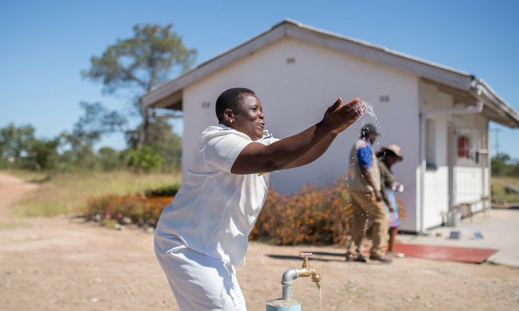 Nurse Tsitsi celebrates having running water for the first time at Somerton clinic in Masvingo District, Zimbabwe.